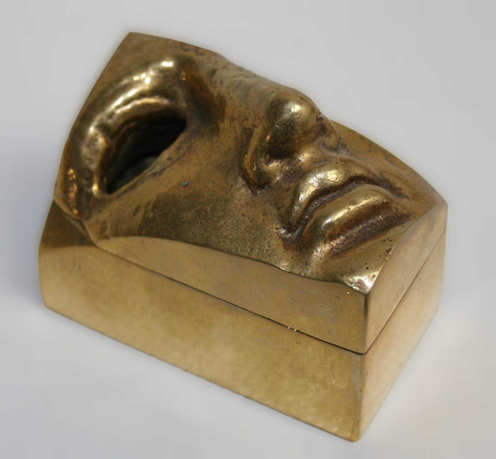 Stelios Gavalas aluminium box sculpture of a gold blind face