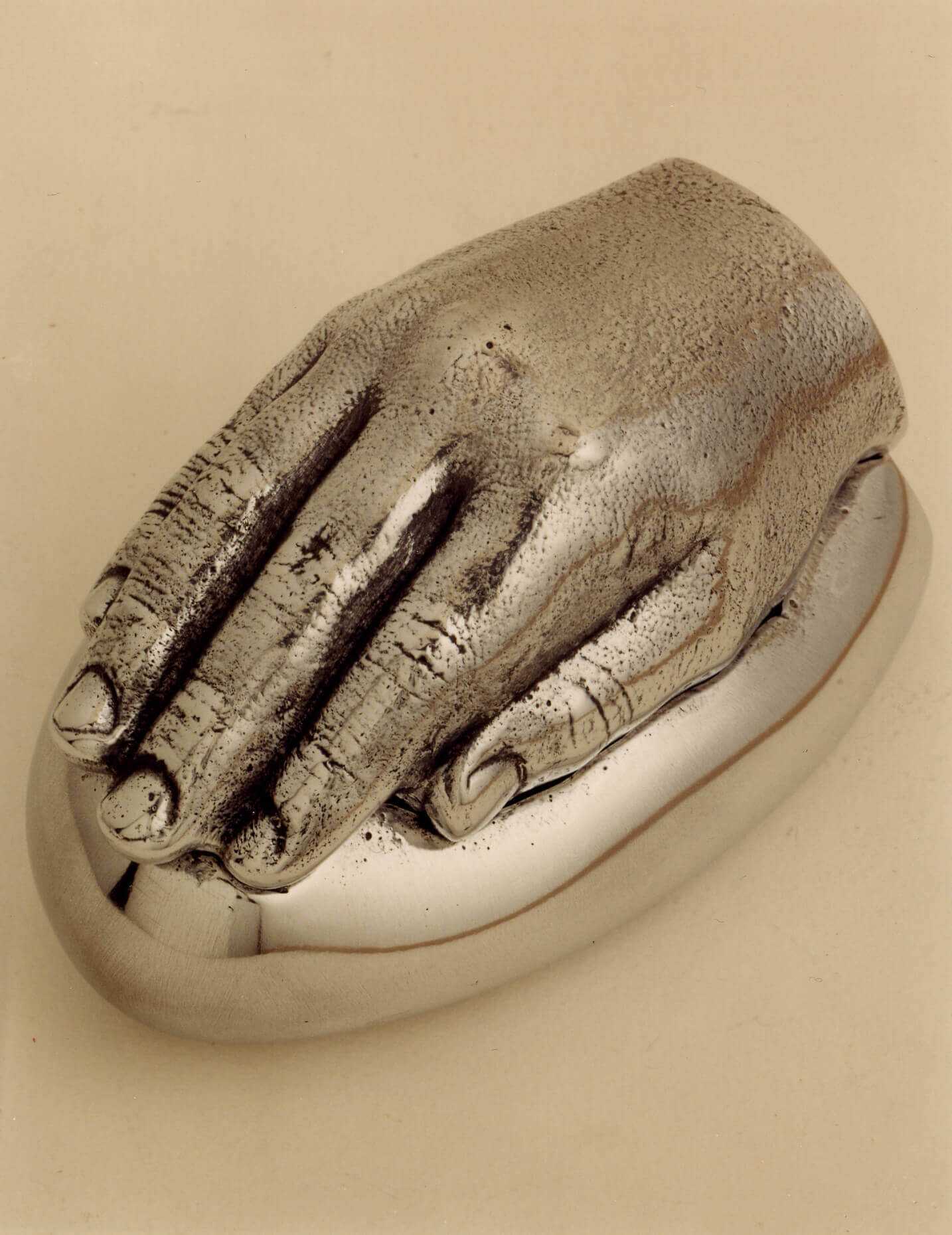 Stelios Gavalas aluminium box sculpture of a silver hand.